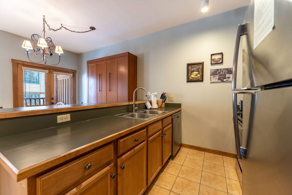 Your fully equipped kitchen awaits with warm wood cabinets, stainless appliances, and everything needed to create delicious meals during your stay.