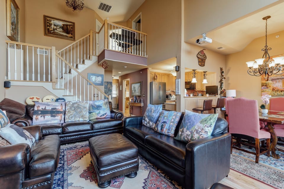Spacious living room with cozy leather seating and vaulted ceilings