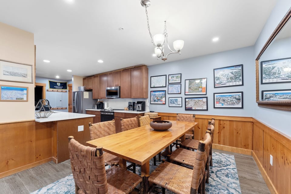 Gather around your beautiful wooden table with wicker chairs, perfect for family meals and game nights in this welcoming mountain-inspired space.