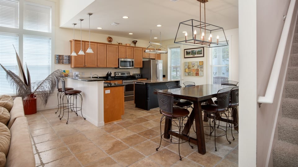 Kitchen And Dining Area With Bar Seating