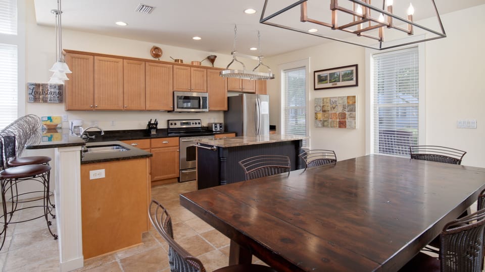 Kitchen And Dining Area With Bar Seating