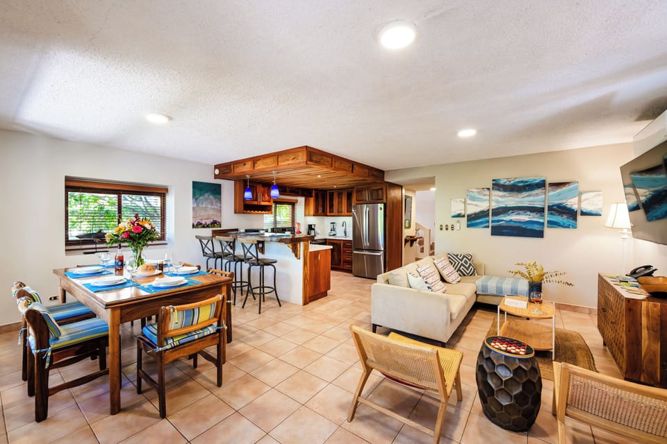 Bright open‑concept kitchen, dining, and living room at Villas Langosta #1 in Playa Langosta, Tamarindo Costa Rica. Featuring quartz countertops, stylish décor, and spacious design, this beachfront vacation rental is ideal for family vacations.