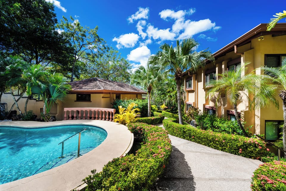 Pool at Playa Langosta, Tamarindo Costa Rica vacation rental with sparkling water under the sun. Tropical setting offers refreshing swim, ocean breeze, and relaxing retreat for family vacations surrounded by lush garden and beachside charm.