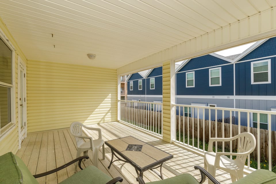 Relax on your private covered balcony with comfortable seating and peaceful residential views.