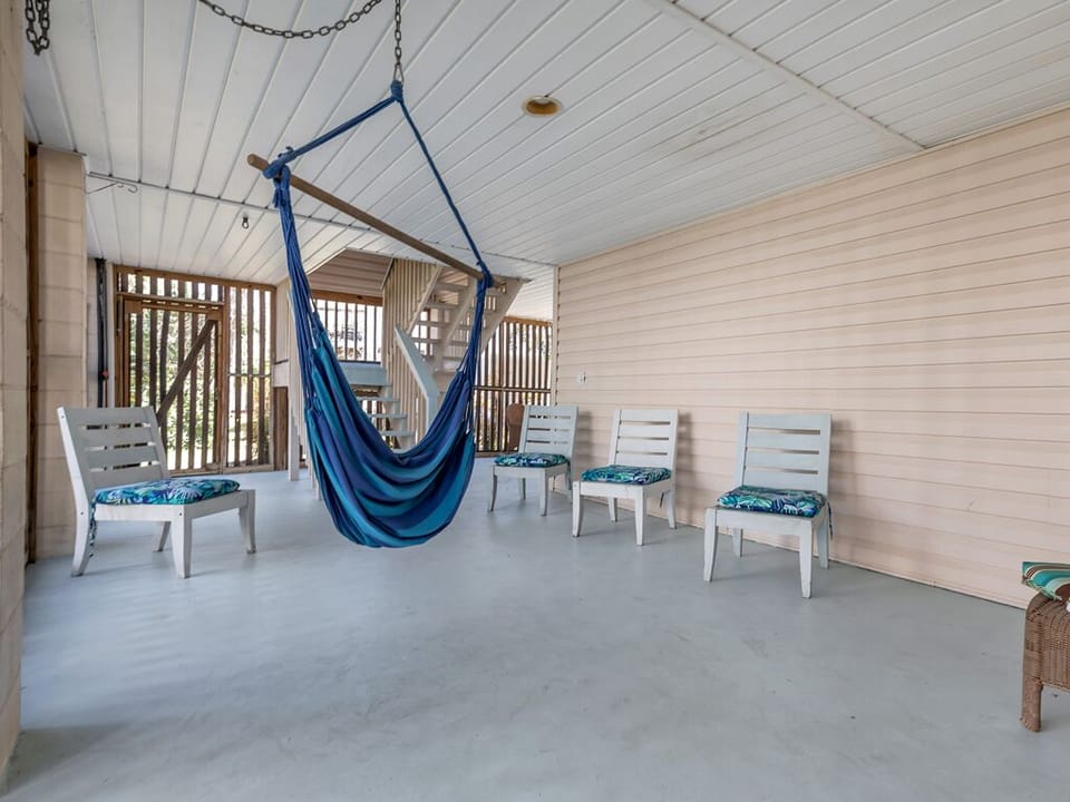 Covered, enclosed patio beneath the home