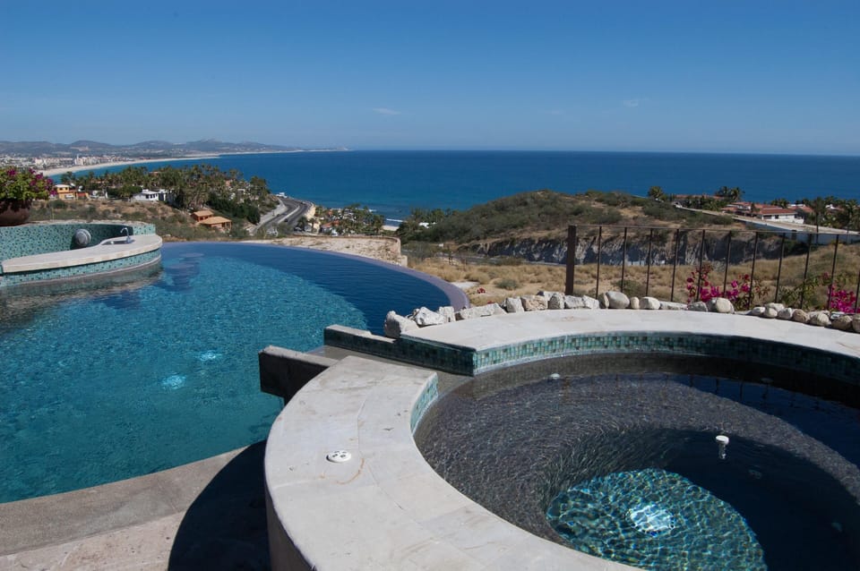 Poolside patio with jacuzzi and infinity pool