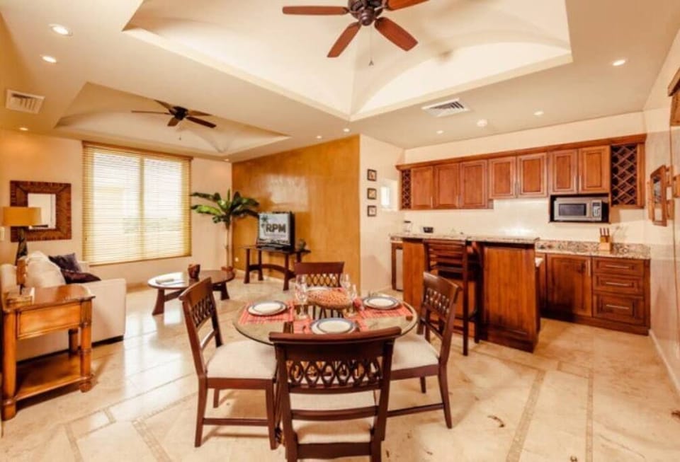 The second floor of this condo has a second kitchen, living area, and dining table. 