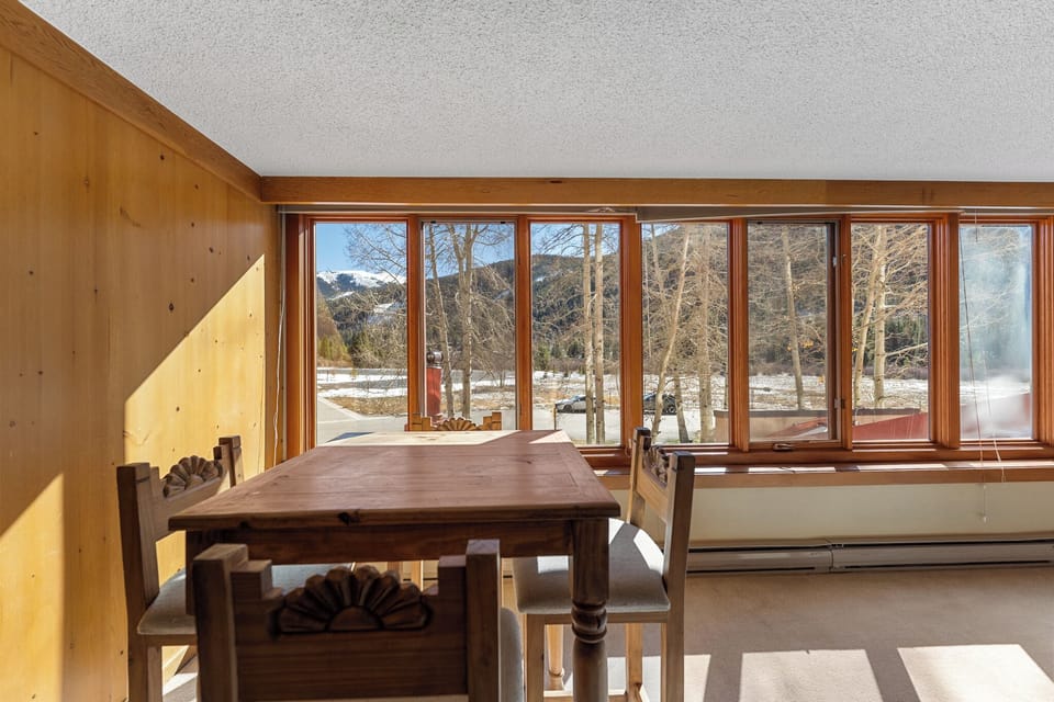 Your dining nook offers stunning mountain views through panoramic windows, where you'll savor meals surrounded by snow-dusted peaks and winter tranquility.