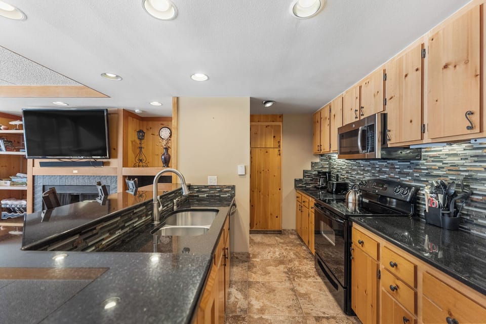 Your fully-equipped kitchen features granite counters, modern appliances, and a cozy breakfast bar where morning coffee tastes even better.