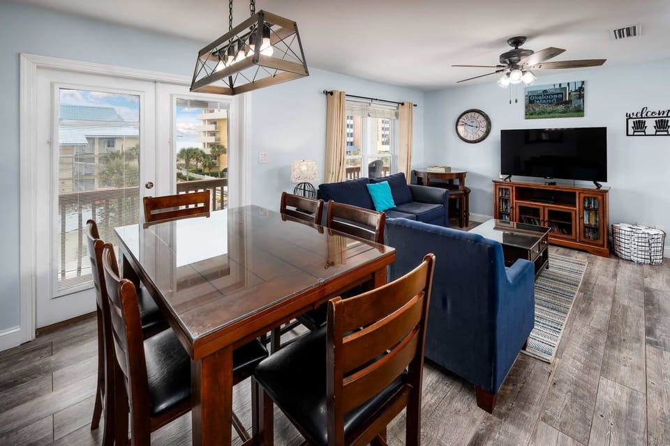 Dining table with seating for six and balcony doors