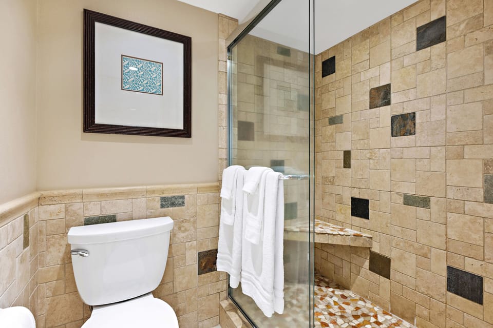 Beautiful newly remodeled bathroom with glass and tile surrounded shower