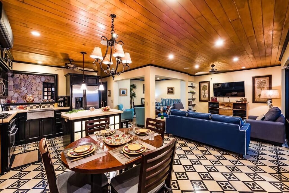 Spend some time away from the sun in this open kitchen, living room, and dining area. 