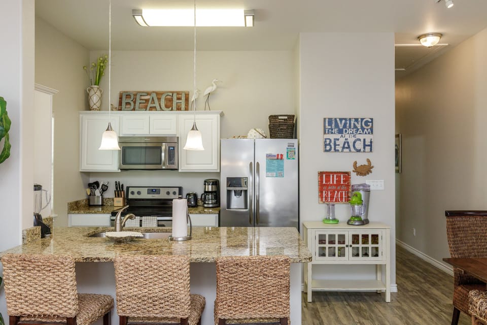 Your fully equipped kitchen awaits with granite counters, stainless appliances, and charming beach-themed touches that set the perfect coastal vacation mood.