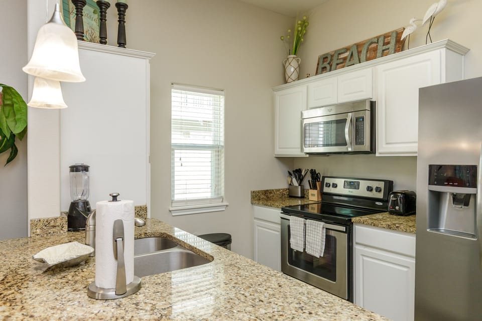 Cook up your favorite meals in this fully equipped kitchen featuring granite countertops, stainless steel appliances, and everything you need for a perfect stay.