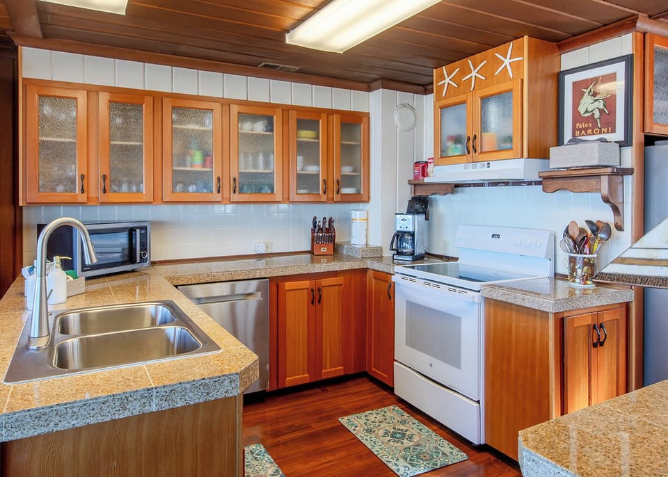 Kitchen - Glass top stove and all the supplies you need for creating a masterpiece.