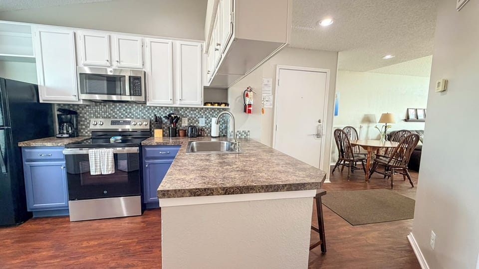 Your fully equipped kitchen features granite countertops, stainless steel appliances, and an open layout that flows seamlessly into the dining area.