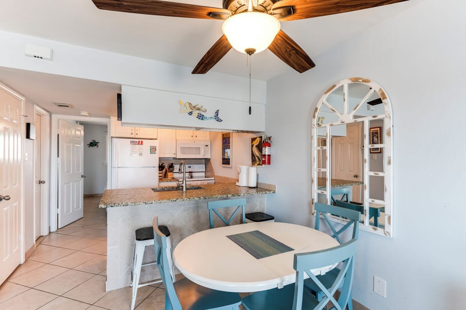 Your open-concept kitchen and dining area features granite countertops, modern appliances, and a cozy breakfast bar perfect for morning coffee.