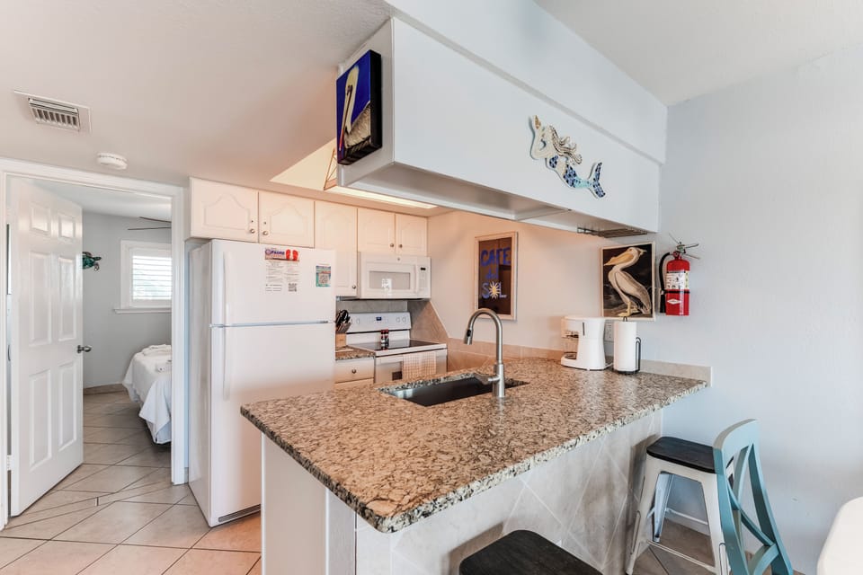 Your fully equipped kitchen awaits with granite counters and modern appliances, perfect for preparing meals during your stay.