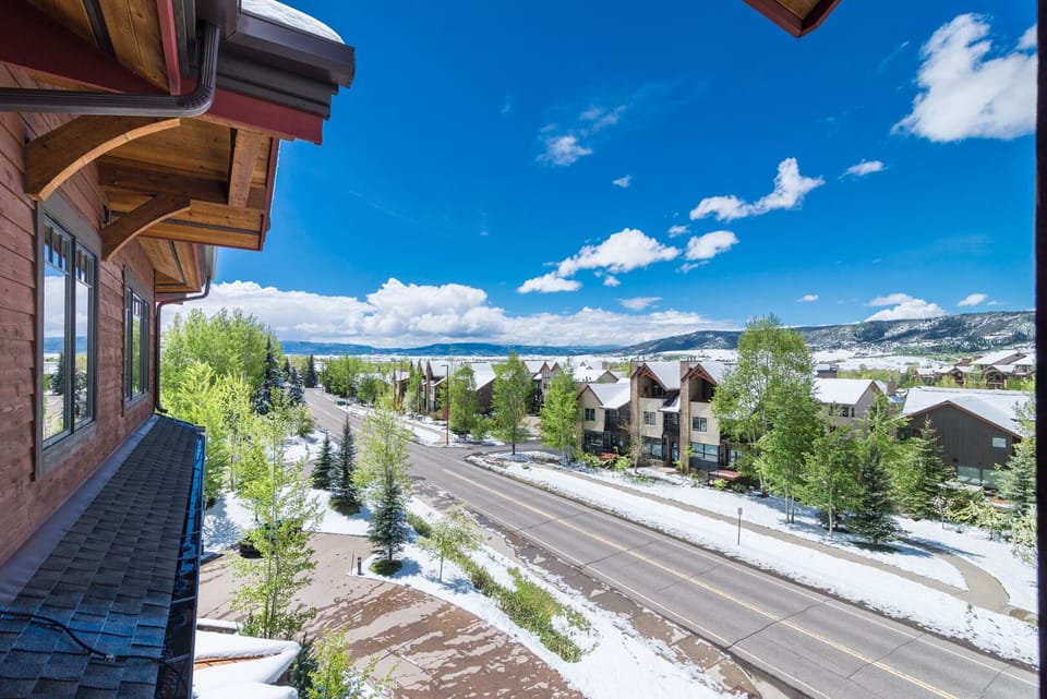 Mountain town views showcase peaceful residential streets with snow-dusted landscapes and dramatic peaks in the distance.