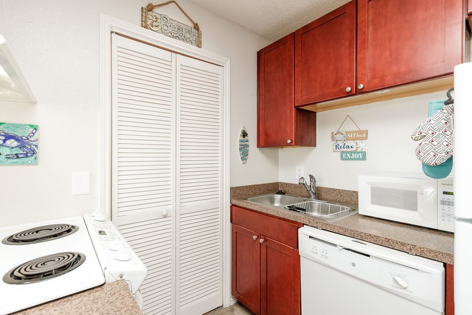 Your fully equipped kitchenette features warm cherry cabinets, granite countertops, and everything you need to prepare meals—from the stovetop to dishwasher.