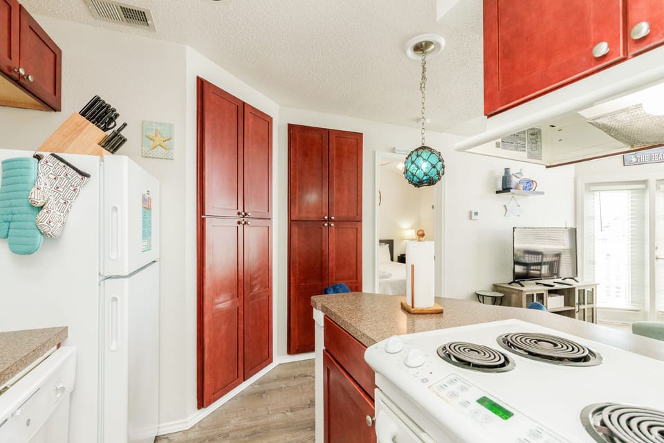 Cook your favorite meals in this fully-equipped kitchen featuring warm cherry cabinets, granite countertops, and modern appliances.