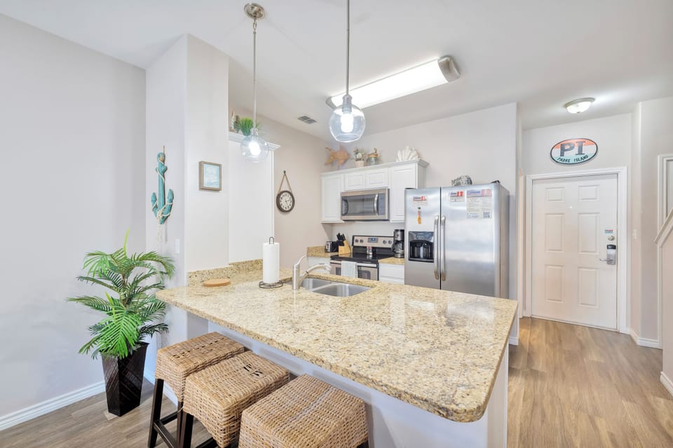 Your spacious kitchen features granite countertops, stainless steel appliances, and a breakfast bar where you can start each morning with coffee.