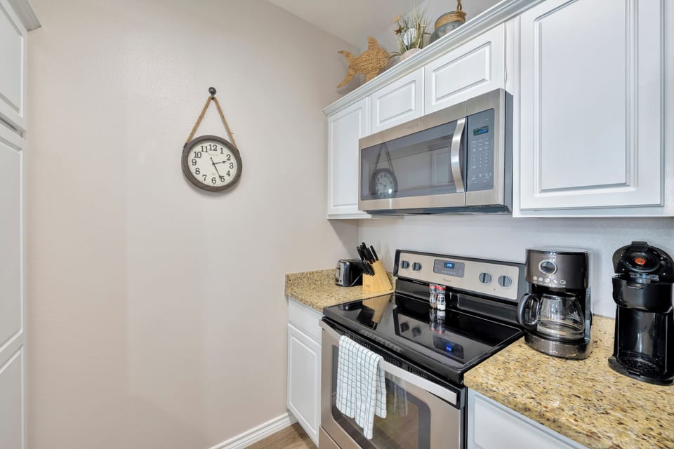 Your fully equipped kitchen awaits with granite counters, stainless appliances, and everything you need to brew morning coffee or prepare meals.