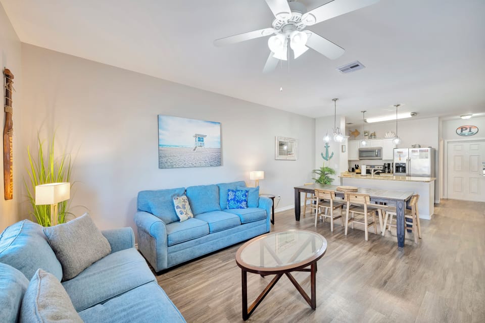 Your spacious open-concept retreat blends coastal charm with modern comfort, featuring a bright kitchen and cozy living area perfect for memorable gatherings.