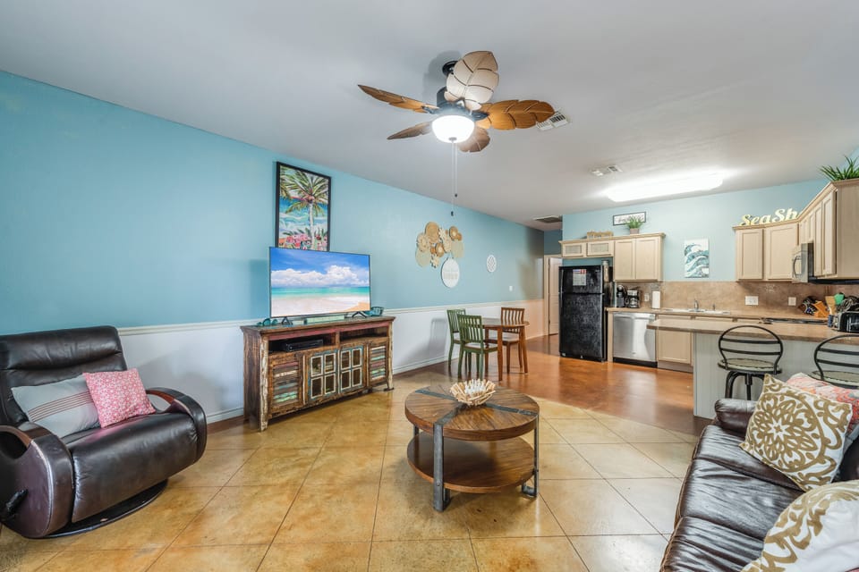 Unwind in your coastal-themed living space with comfortable seating, full kitchen, and beach-inspired décor that makes you feel right at home.
