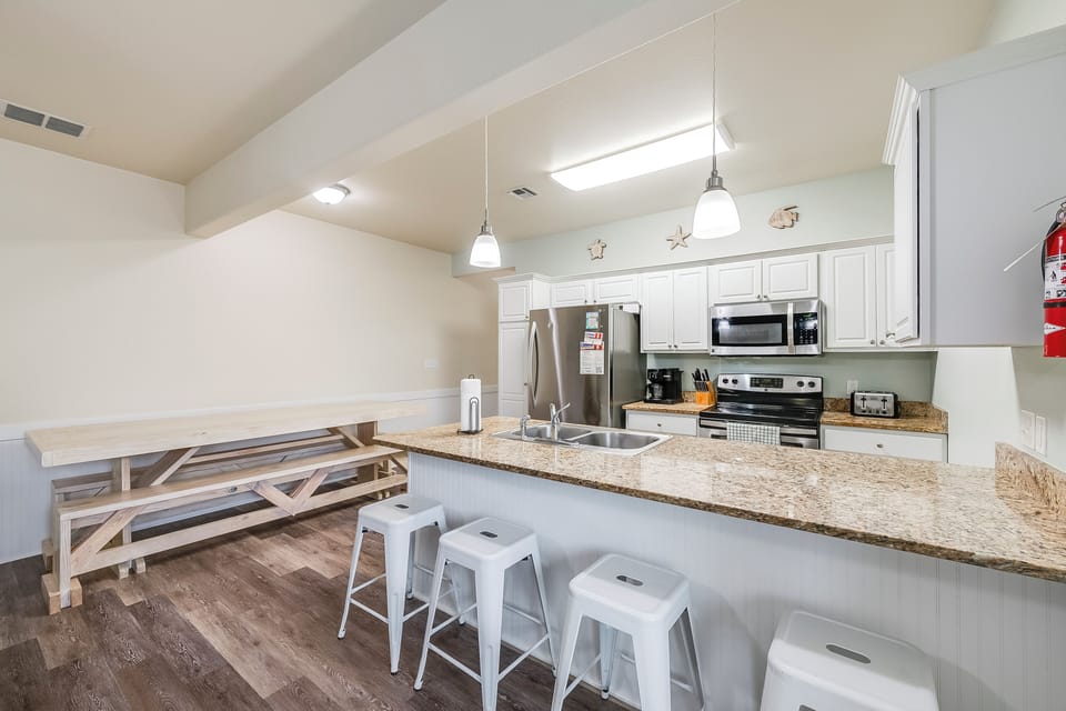 Your fully equipped kitchen features granite counters, stainless appliances, and a breakfast bar where you can sip morning coffee.