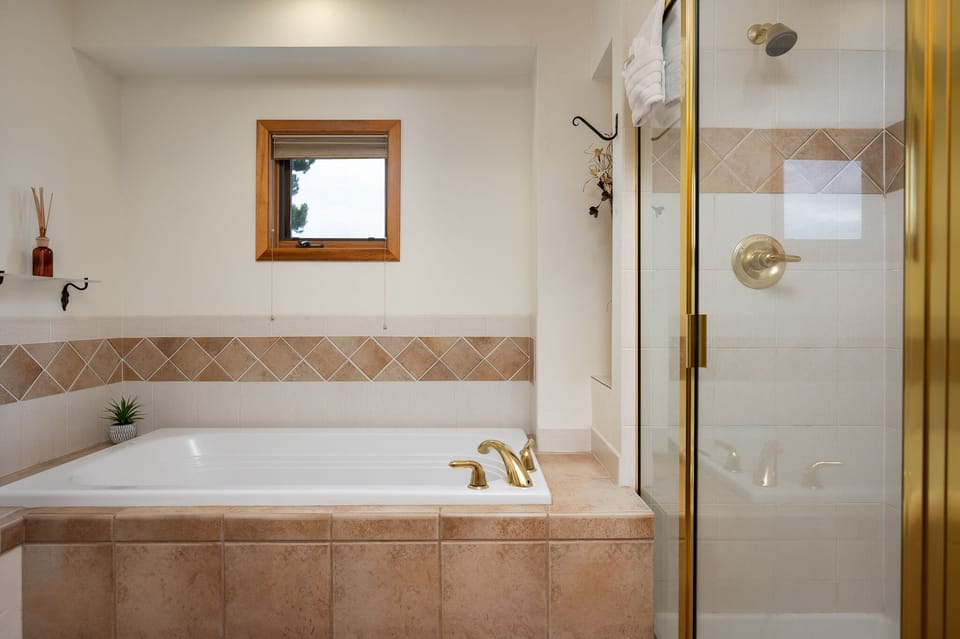 Ensuite bathroom with stand alone shower and bathtub