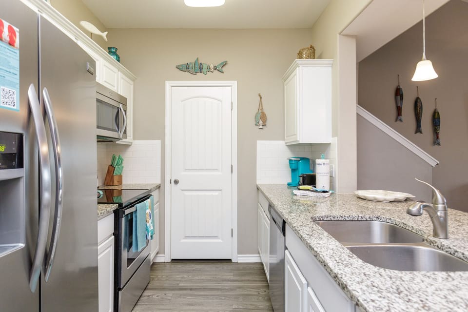 Cook your favorite meals in this fully-equipped kitchen with granite counters and modern appliances.