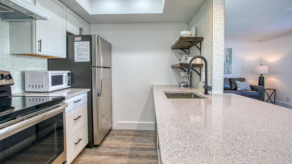 Bright and Open Kitchen With Stainless Steel Appliances and Quartz Countertops