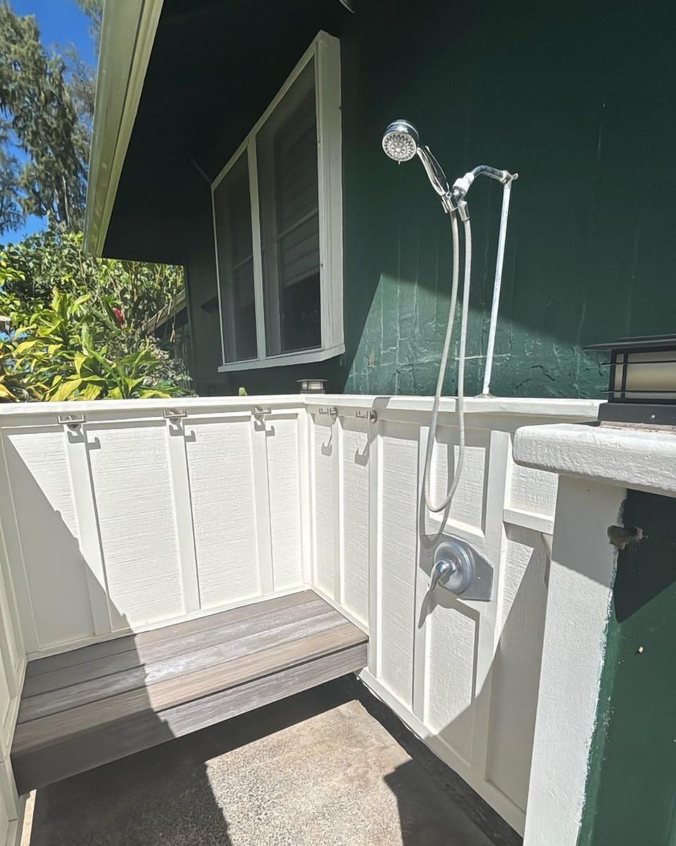 Outdoor shower has bench available