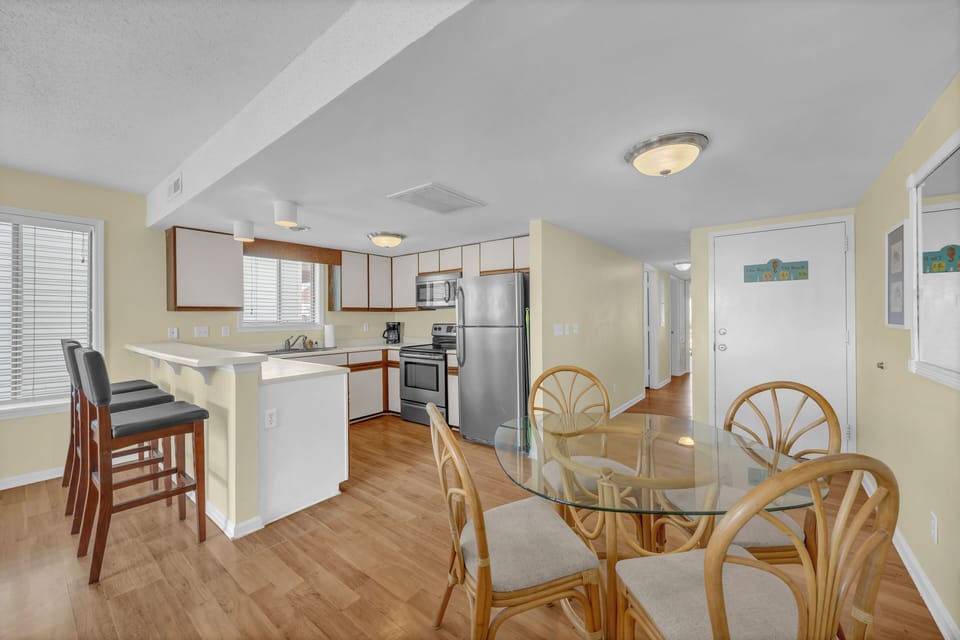 Step into your bright, open-concept space where kitchen and dining flow together. Stainless steel appliances and a breakfast bar make cooking and gathering effortless in this sunny, welcoming home.