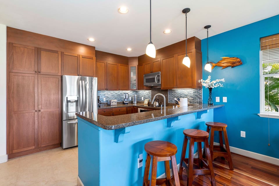 Kitchen with Breakfast Bar, fridge, and oven.