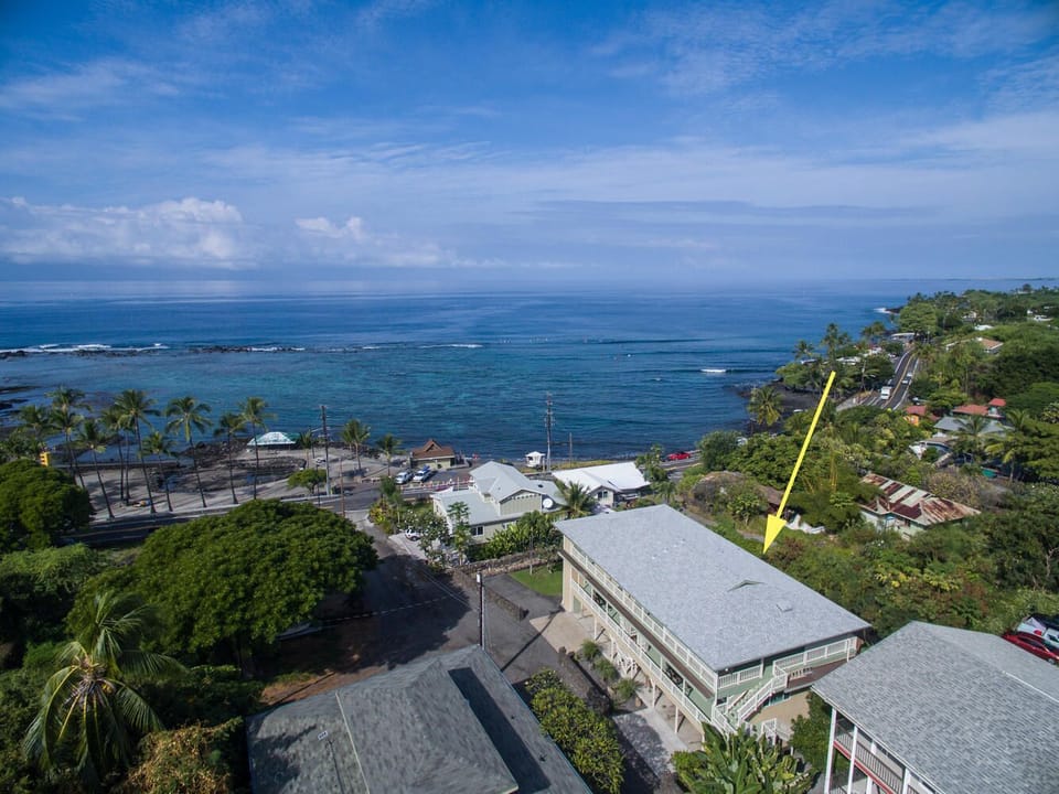 Picture of this home from afar, a yellow arrow pointing to it.