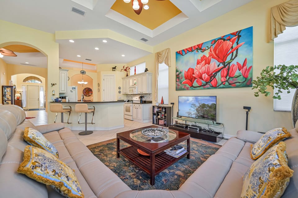 GR12597 - The family room is equipped with a large sectional and a  flat screen TV
