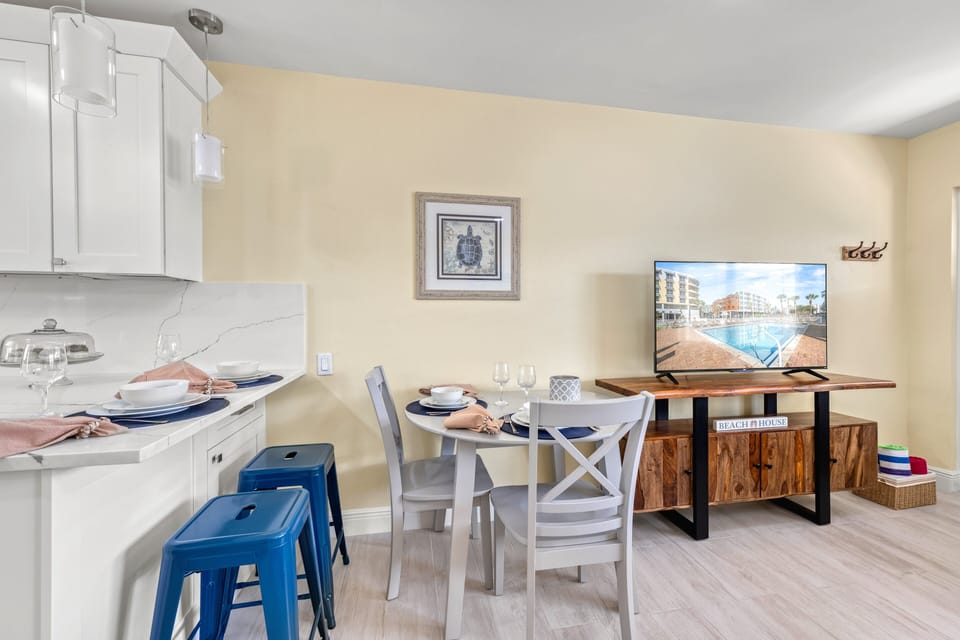 Gather around the cheerful dining table for meals, games, or planning your next adventure on Siesta Key.