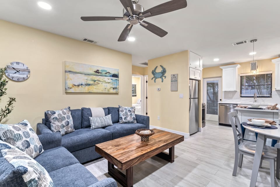 A bright, open space where the living area flows seamlessly into the fully equipped kitchen, ideal for shared meals and together time.