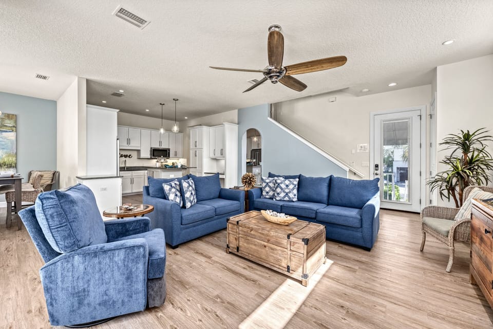 Spacious open-plan living with plush seating and a TV—ideal for relaxing.