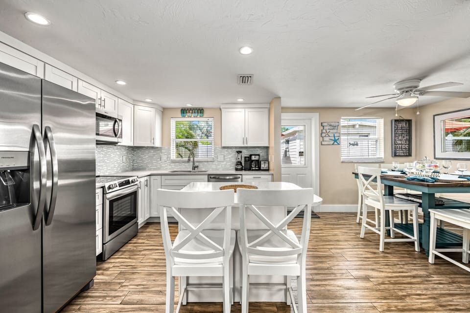 Picture breakfast smoothies whirring, pancakes flipping, and friends gathering around the island—here, conversations flow as easily as the coffee, with the kitchen and dining room seamlessly connected in the heart of the home.