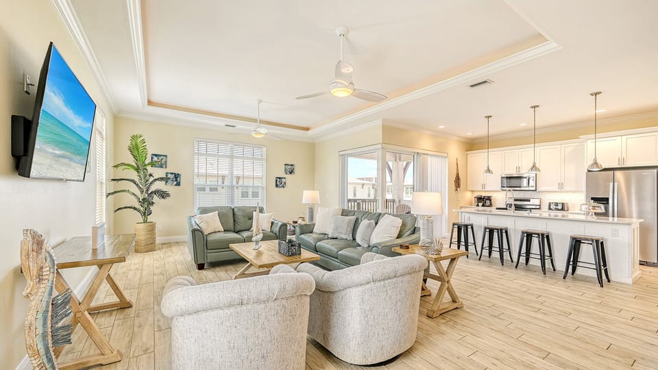 Kick back in a bright, open space where the kitchen's breakfast bar sets the scene for casual chats and morning coffee rituals.