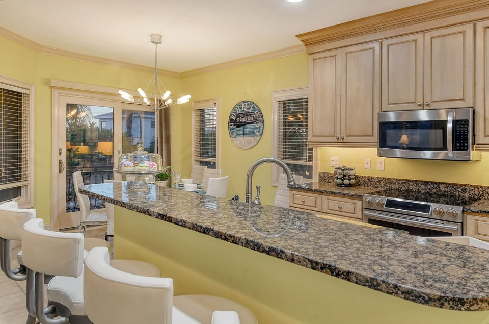 Kitchen breakfast bar.  Natural stone countertops.
