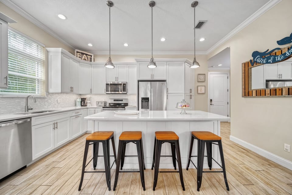 Kitchen island with breakfast bar—grab a quick bite or sip coffee while chatting with the chef in this breezy open layout.