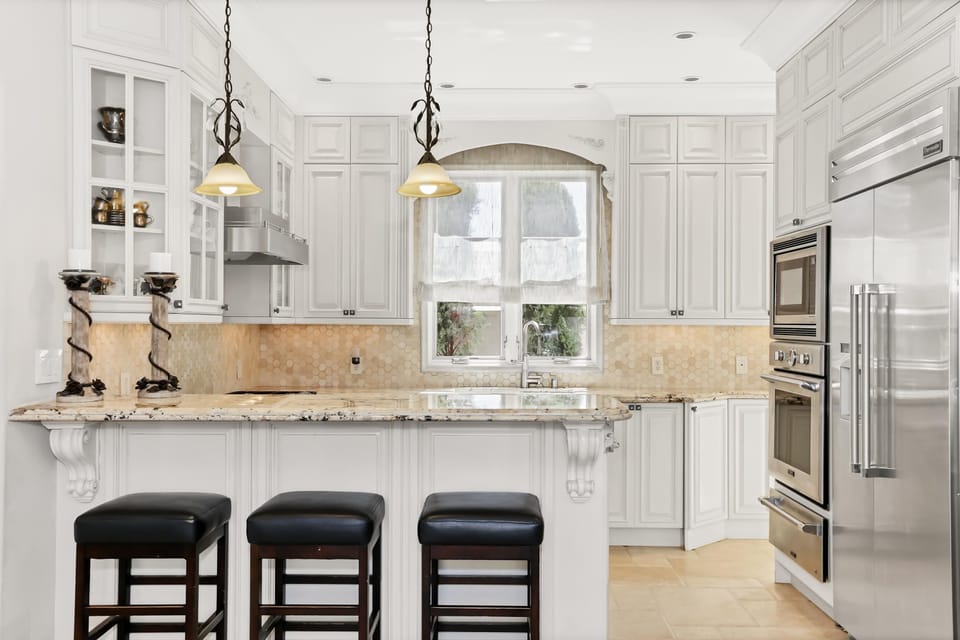 Gourmet kitchen delights the senses with most beautiful granite and state of the art stainless steel appliances