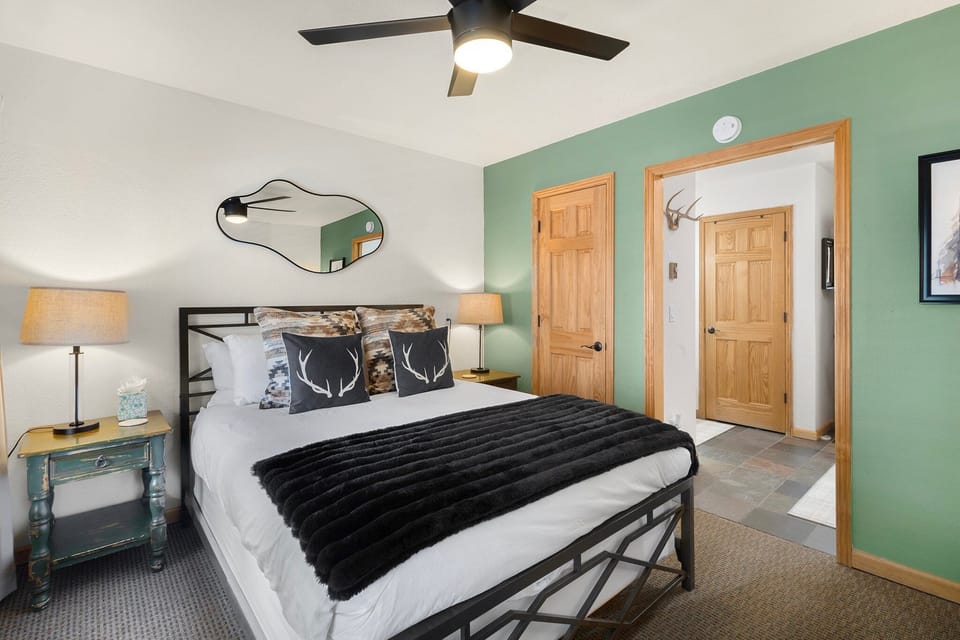 Step into the unit through the bright and fresh primary bedroom, featuring a comfortable queen bed.