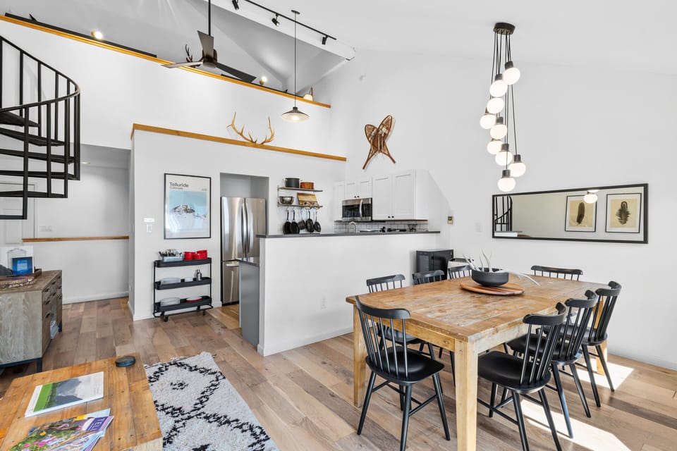 Open space living room, kitchen and dining with loft above.