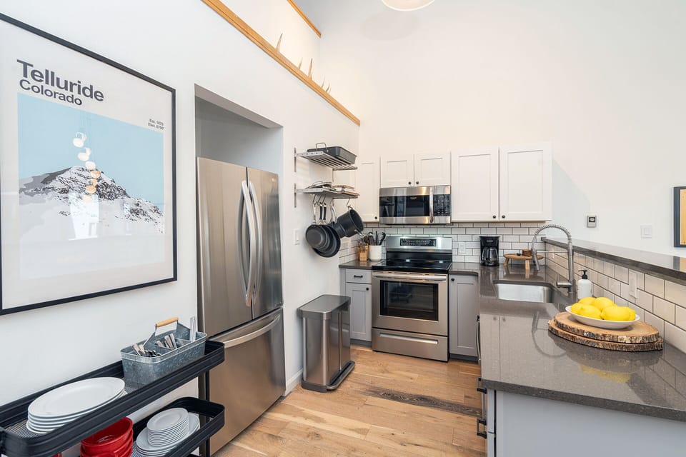 The kitchen is a chef's delight with professional grade cookware and small appliances including a blender, mixer, waffle iron, tea kettle, coffee maker, coffee grinder, and French press.