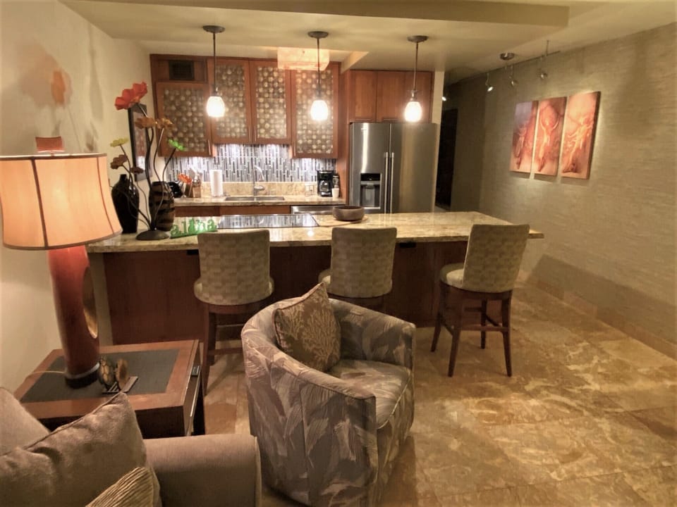 Your elegantly designed open-plan living space features a full kitchen with granite countertops, modern appliances, and a breakfast bar where you can enjoy morning coffee or evening cocktails in sophisticated comfort.
